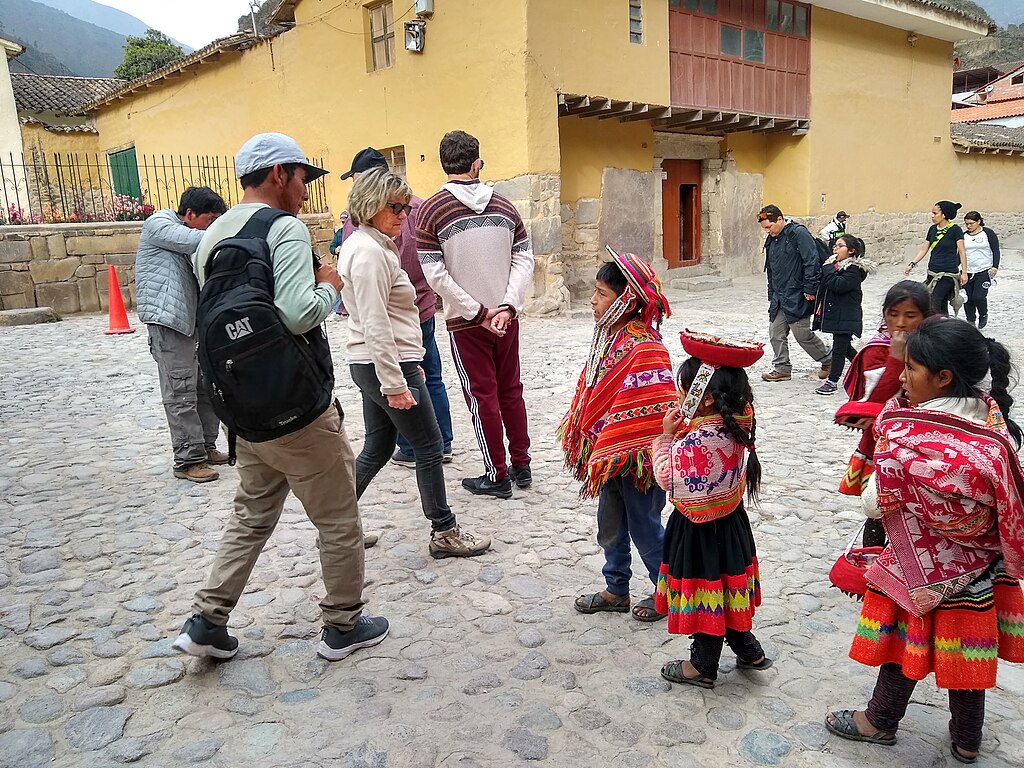 Ollantaytambo Peru- indigenous children begging tourists to give them money for photo