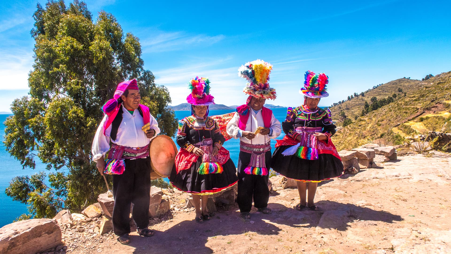 Welcoming scene at Lake Titicaca with reed boats and locals in traditional attire.